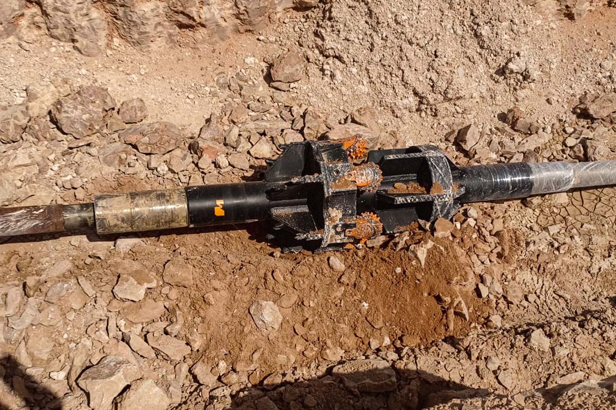 hole opener drilling tool for enlarging pilot holes in hard rock